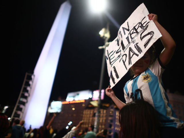 BUENOS AIRES, ARGENTINA – NOVEMBER 19: A supporter of newly elected Argentine President Javier Miley from La Libertad Avanza holds a sign reading: "Finally my country is free" After polls close in the presidential runoff on November 19, 2023 in Buenos Aires, Argentina.  According to the official results, Javier Miley from La Libertad Avanza received 55.69% of the votes, and Sergio Massa from Union Por la Patria received 44.30% after 99.25 votes were counted.  The presidential election runoff to succeed Alberto Fernandez comes at a time when Argentines have been hit hard by an annual inflation rate of 142.7%.  (Photo by Thomas Cuesta/Getty Images)