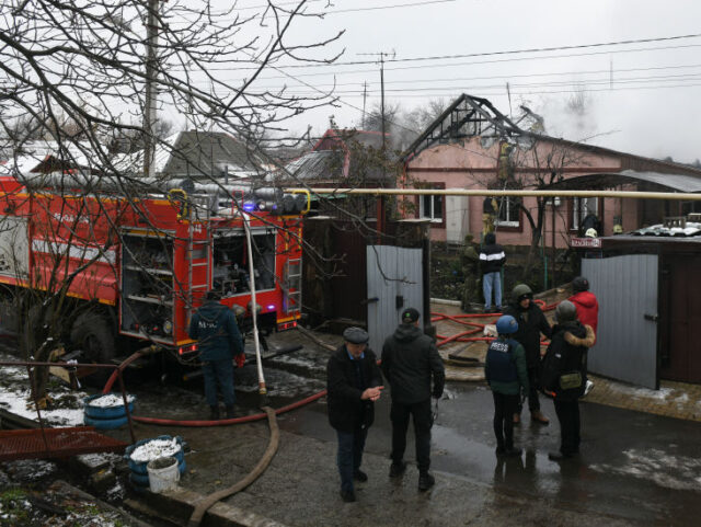 Firefighters work to extinguish a fire in a house hit by recent shelling in Donetsk, Russi