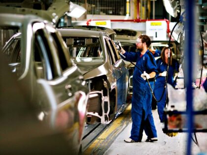 Employees work on the assembly for the Jeep Cherokee inside the Chrysler Toledo Assembly P