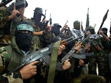Palestinian militants representing the armed wings of Hamas, Islamic Jihad and the Popular Resistance Committees as well as the Al-Aqsa Martyrs Brigades and Abu Rish Brigades, gather in the southern Gaza Strip border town of Rafah 06 January 2006 to read a joint statement to reporters calling for an end …