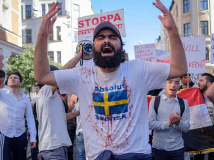 MALMö, SKåNE, SWEDEN - 2017/06/17: A protester seen shouting slogans while wearing a t-shirt covered with fake blood as a sign of protest during a demonstration against migrants deportation. As in many other Swedish cities, people gathered to demonstrate against the Swedish asylum policy and that asylum seekers are deported …