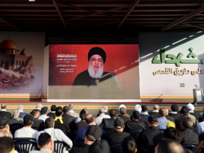 Supporters of the Lebanese Shiite movement Hezbollah watch a televised speech by its leade