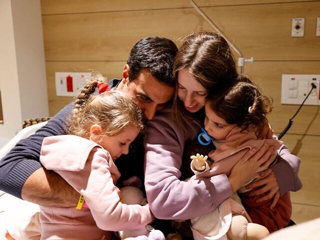 The Asher family, reunited after the mother and daughters (four and two years old) were re
