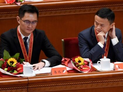 Alibaba's co-founder Jack Ma (R) looks at Tencent Holdings' CEO Pony Ma during a celebration meeting marking the 40th anniversary of China's "reform and opening up" policy at the Great Hall of the People in Beijing on December 18, 2018. - President Xi Jinping warned on December 18 that no …