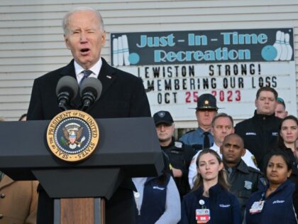 US President Joe Biden speaks surrounded by first responders, nurses, and others on the fr