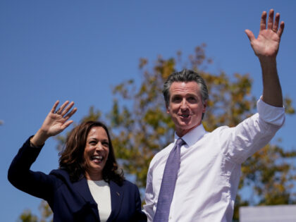 Vice President Kamala Harris stands on stage with California Gov. Gavin Newsom at the conc