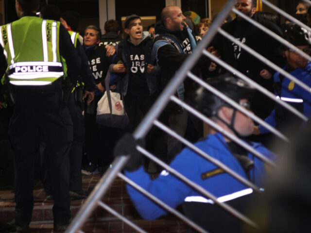 WASHINGTON, DC - NOVEMBER 15: Protesters block the entrance of the headquarters of the Dem
