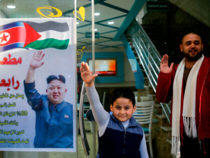 Salam Rabaa (L), the Palestinian owner of Rabaa restaurant and his son gesture with their