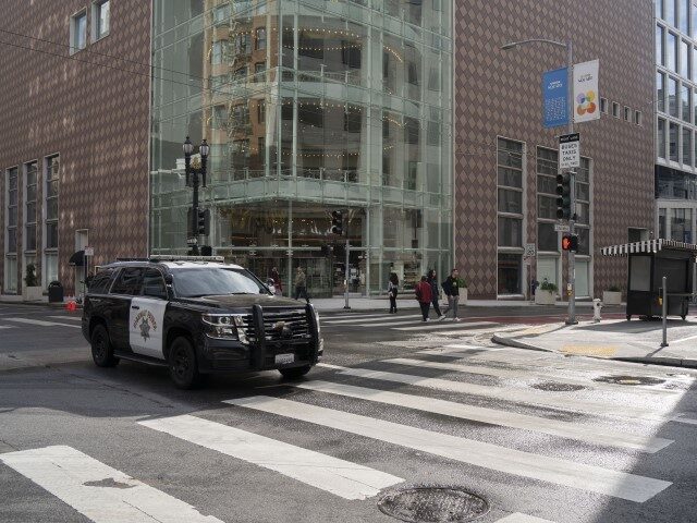 A police car runs along a clean street near Union Square during the 2023 Asia-Pacific Econ