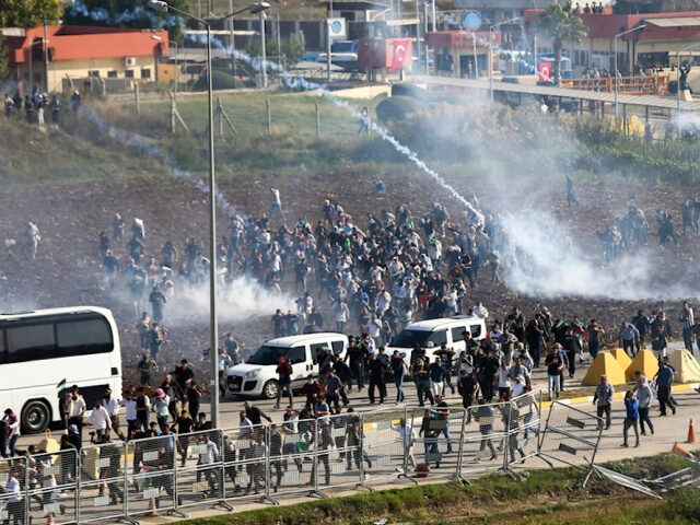 People clash with anti riot Turkish police officers during a protest to show their solidar