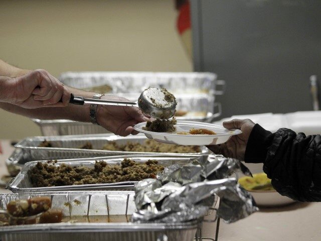 A Salvation Army volunteer serves stuffing during a free Thanksgiving Day meal held for co