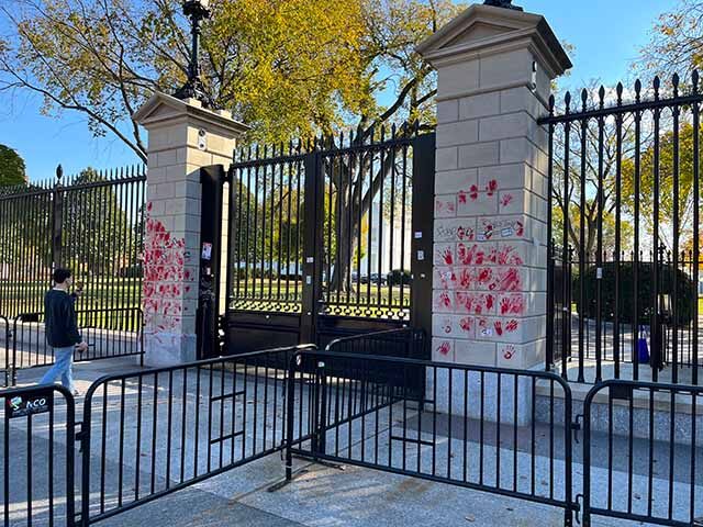 Red handprints covered the gate columns outside of the West Wing entrance to the White House after Saturday's protests.
