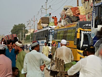 Pakistan's Afghan refugees load their belongings onto a bus at the Karachi bus termin