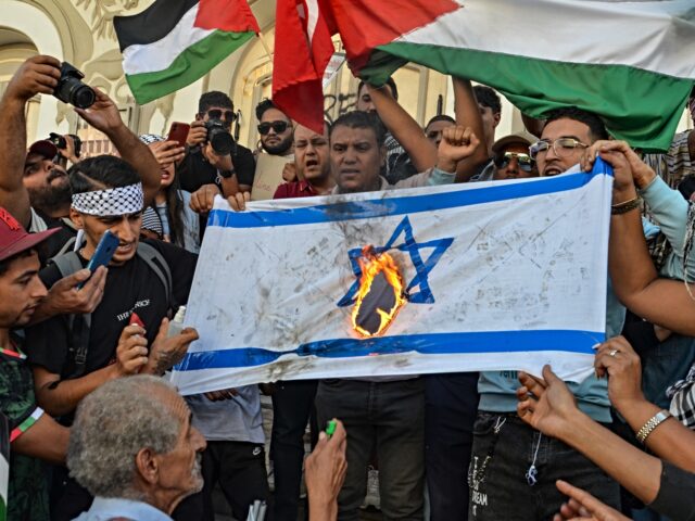 TUNIS, TUNISIA - OCTOBER 21: People burn the Israeli flag during a protest to express their solidarity with Gaza in the Tunisian capital Tunis on October 21, 2023, amid the ongoing battles between Israel and the Palestinian group Hamas. There has been an escalation in pro-Palestinian demonstrations worldwide, following the …