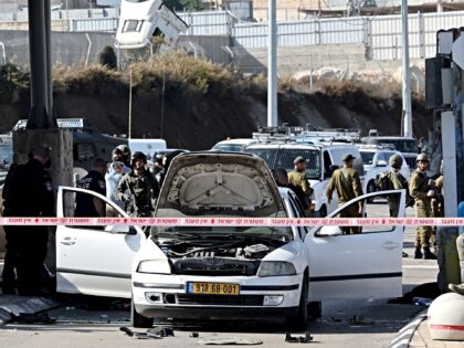 israeli police officers secure the scene after an attack by gunmen on a checkpoint guardin