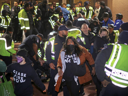 WASHINGTON, DC - NOVEMBER 15: Members of U.S. Capitol Police try to remove protesters from the headquarters of the Democratic National Committee during a demonstration against the war between Israel and Hamas on November 15, 2023 on Capitol Hill in Washington, DC. Jewish Voice for Peace and If Not Now …