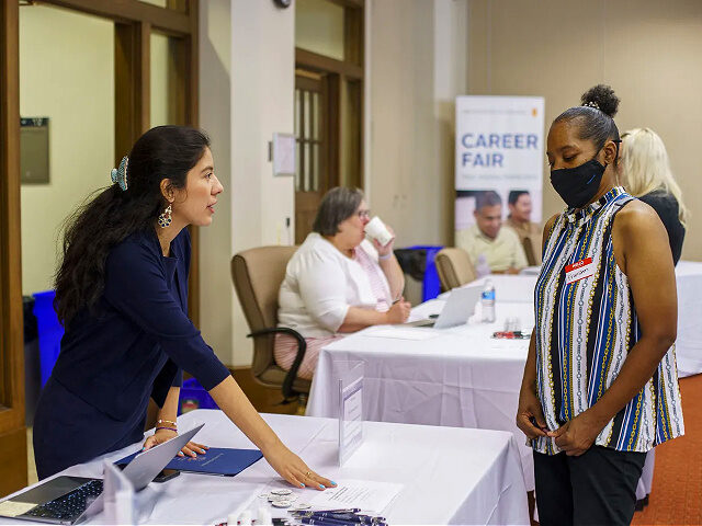Jennifer Franco, left, director of marketing admissions at St. Albert the Great Catholic School, talks with Franshon Jackson during a job fair hosted by the Archdiocese of Chicago on Aug. 24, 2022. (Armando L. Sanchez/Chicago Tribune/Tribune News Service via Getty Images)