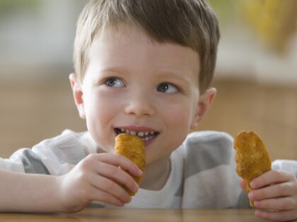 child eating chicken nuggets