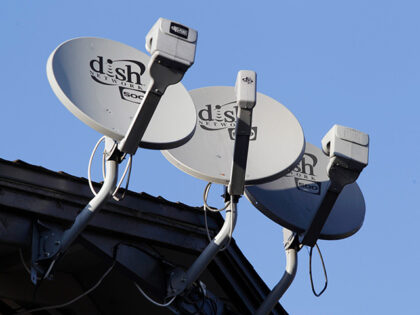 Dish Network satellite dishes are shown at an apartment complex in Palo Alto, Calif., Feb.