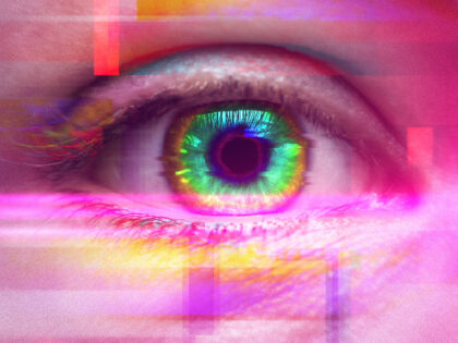 Female eye with colorful iris. Effect of using psychoactive drug and having psychedelic tr