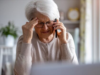 elderly woman upset on phone