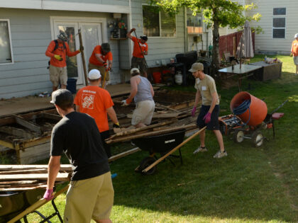 Volunteers build a new fence and desk for family in Littleton