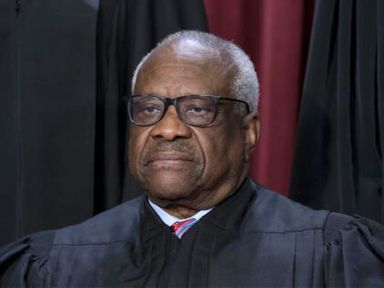 FILE - Associate Justice Clarence Thomas joins other members of the Supreme Court as they