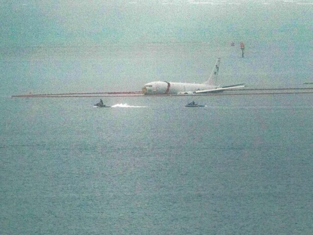 A military aircraft is seen in the shallow waters of Kaneohe Bay after skidding off the end of the runway at Marine Corps Hawaii in Kaneohe on November 20, 2023. The aircraft is a Boeing P8 Poseidon, described as a military surveillance and patrol aircraft. According to the Hawaiian press, …