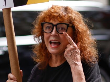 NEW YORK, NEW YORK - AUGUST 17: US Actress Susan Sarandon holds a banner as she joins WGA