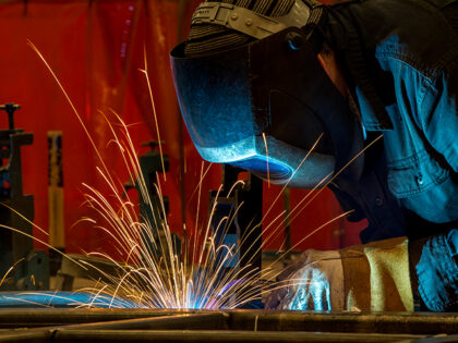 An employee welds the shell frame of a train car at the Siemens Industry Inc. manufacturin