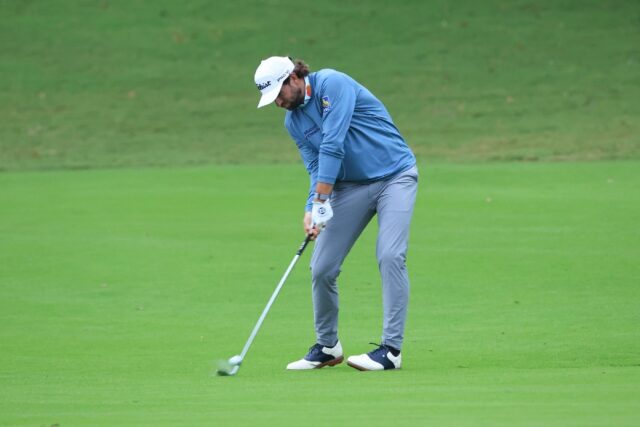 American Cameron Young hits a shot from the ninth fairway on the way to a share of the fir