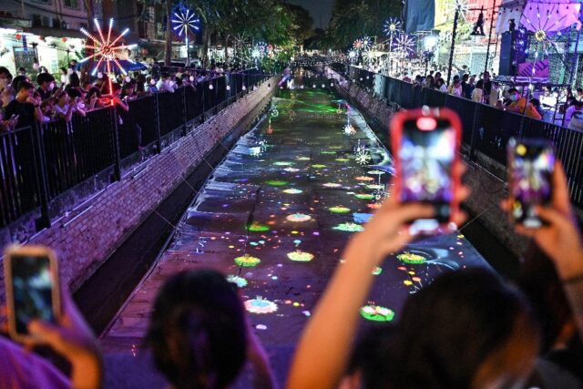 Digital floats are projected onto Bangkok's Ong Ang Canal during the annual Loy Krathong f