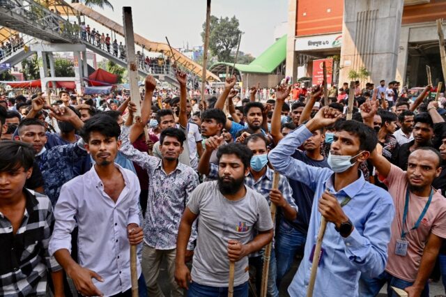 Garment workers block roads as they take part in a protest in Dhaka demanding a nearly thr