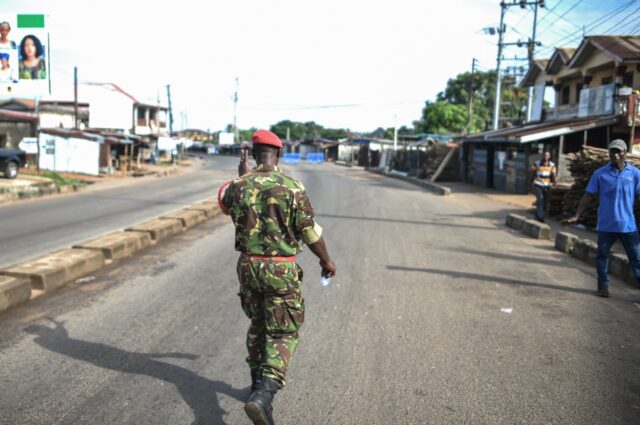 A military policeman walks the empty streets of Freetown