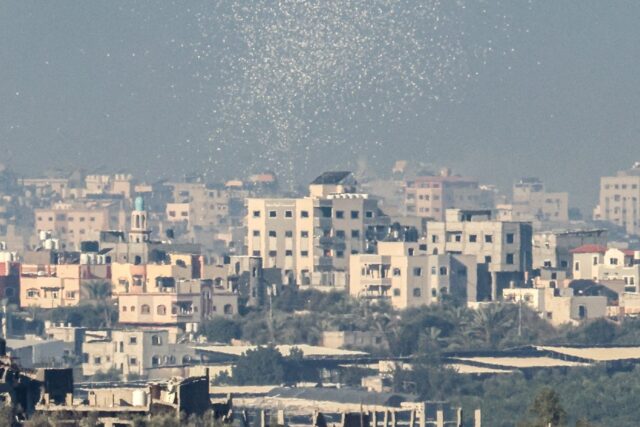 A picture taken from the border between Israel and Gaza shows leaflets dropped by the Isra