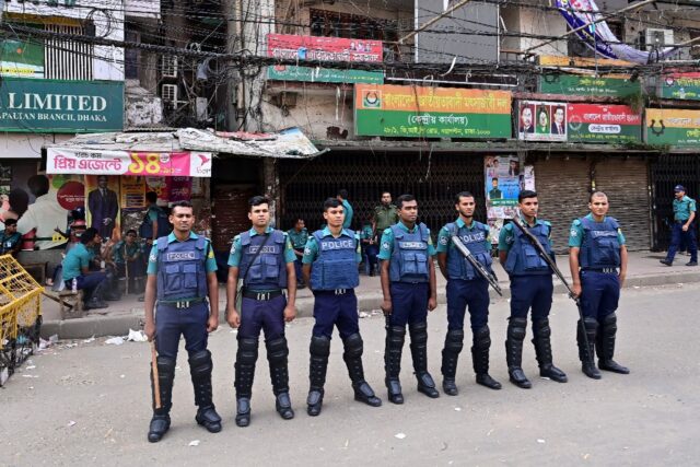 Police stand guard in front of the headquarters of the opposition Bangladesh Nationalist Party, which says its top official is among those detained in a nationwide crackdown