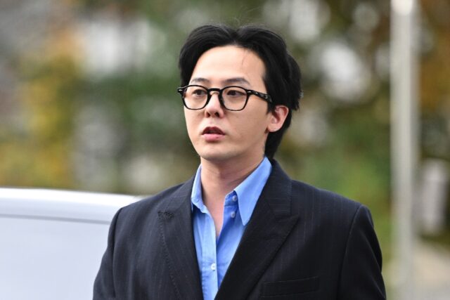 K-pop star G-Dragon arrives at a police station for questioning in Incheon