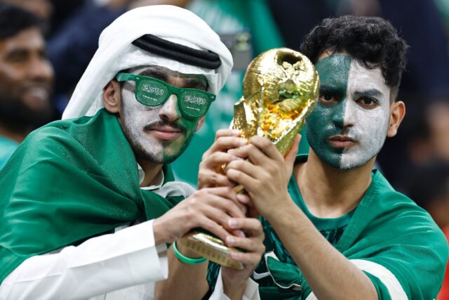 Saudi Arabia supporters holding a replica of the World Cup trophy at last year's tournamen