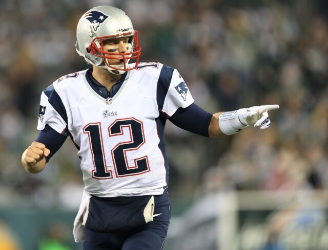 Tom Brady celebrates a touchdown pass for the New England Patriots in a 2012 NFL game agai
