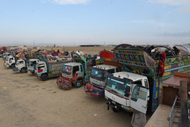 Trucks loaded with Afghans and their belongings wait to cross at Chaman in Pakistan earlie