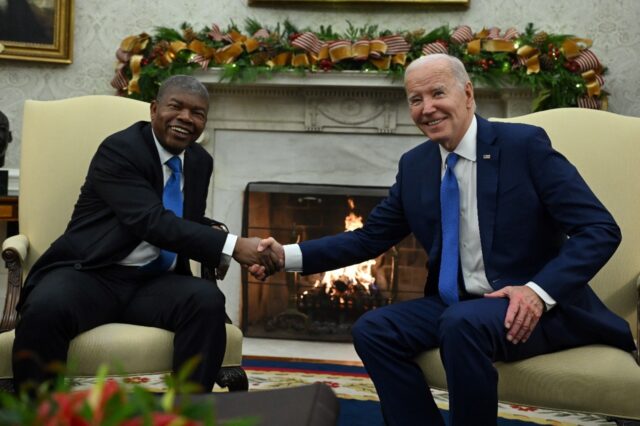 US President Joe Biden (R) shakes hands with Angolan President Joao Lourenco during a meet