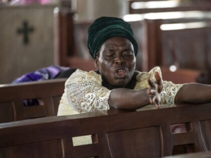 A woman prays during a service at the First African Church Mission in Lagos, Nigeria Sunda