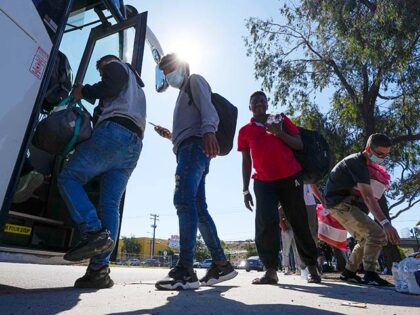Migrants board a bus to the airport Friday, Oct. 6, 2023, in San Diego. San Diego's w