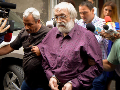 Romanian guru Gregorian Bivolaru is escorted to a vehicle, after a hearing at the Romanian Police headquarters in Bucharest, Romania, Wednesday, Aug. 24, 2016. French authorities arrested the leader of a multinational tantric yoga organization Tuesday Nov. 28, 2023 on suspicion of indoctrinating female followers for sexual exploitation. The Romanian …