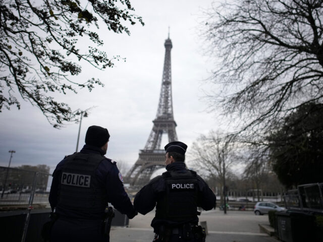 French policemen patrol near the Eiffel Tower after a man targeted passersbys late saturda