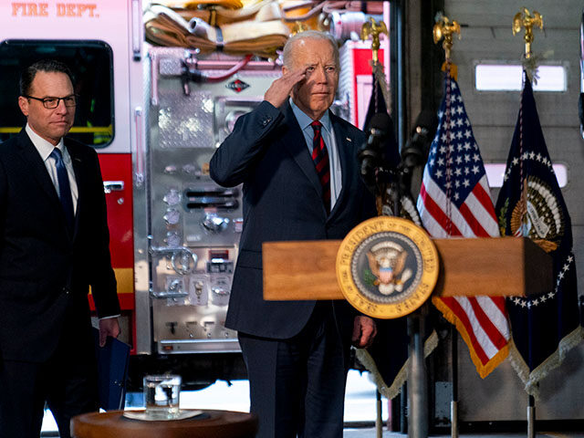 President Joe Biden, accompanied by Pennsylvania Gov. Josh Shapiro, left, salutes firefigh