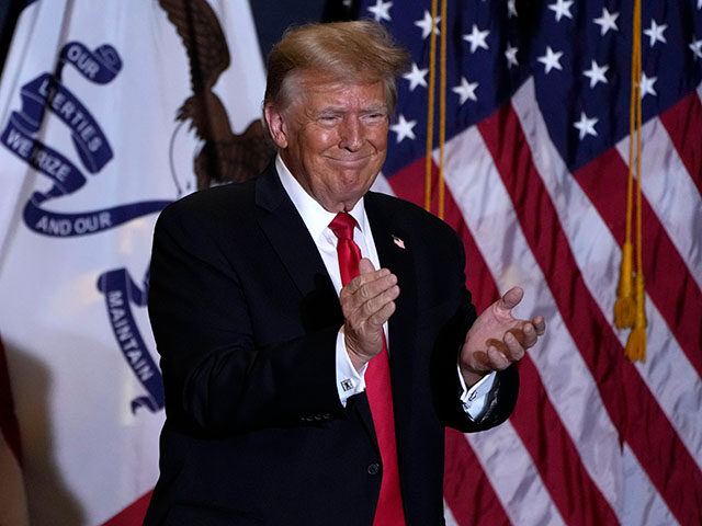 Former President Donald Trump walks off stage during a commit to caucus rally, Wednesday,