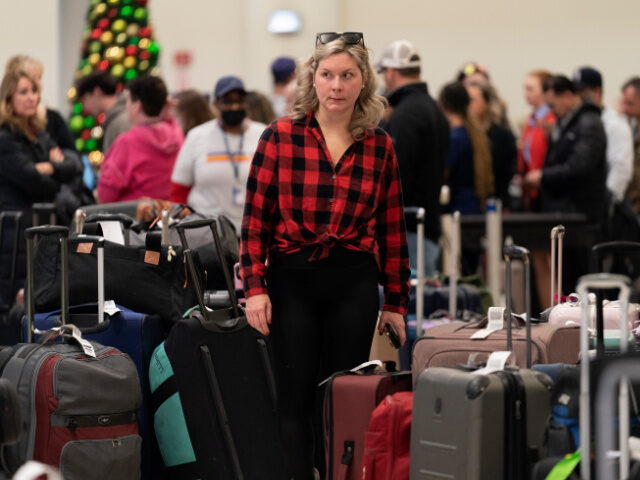 Ashlyn Harmon of New Orleans searches for her Southwest Airlines bags amongst hundreds of
