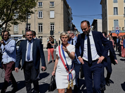 French Prime Minister Edouard Philippe (C-R) and Romans-sur-Isere mayor Marie-Hélène Tho