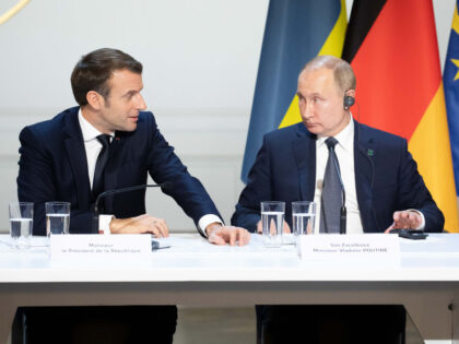 Emmanuel Macron, France's president, left, speaks beside Vladimir Putin, Russia'